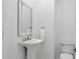 Well-lit powder room with pedestal sink and modern fixtures at 4865 Chesterfield Ct, Suwanee, GA 30024