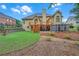 Back of house featuring a deck, screened-in room, large yard, and landscaping at 8108 Greens Mill Way, Loganville, GA 30052