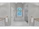 Bright bathroom featuring a soaking tub under a large window and a glass-enclosed shower at 8108 Greens Mill Way, Loganville, GA 30052