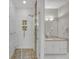 Beautiful bathroom featuring a glass enclosed shower, stone floor, and granite counter at 8108 Greens Mill Way, Loganville, GA 30052