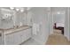 Well-lit bathroom featuring double mirrors and a doorway leading to a bedroom at 8108 Greens Mill Way, Loganville, GA 30052