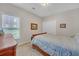 Bedroom with neutral carpet, a window, and double-door closet at 8108 Greens Mill Way, Loganville, GA 30052