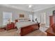 Comfortable bedroom featuring a tray ceiling, large bed, and traditional furnishings, offering a relaxing retreat at 8108 Greens Mill Way, Loganville, GA 30052