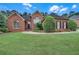 Charming brick home featuring a well-kept lawn and professionally designed landscaping for an inviting exterior at 8108 Greens Mill Way, Loganville, GA 30052