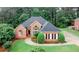 Beautiful brick home with manicured lawn, professional landscaping, and mature trees offering curb appeal at 8108 Greens Mill Way, Loganville, GA 30052