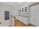 Hallway with hardwood floors and built-in storage, a perfect blend of style and functionality at 8108 Greens Mill Way, Loganville, GA 30052