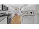 Spacious open kitchen featuring white cabinets, granite countertops, and stainless-steel appliances at 8108 Greens Mill Way, Loganville, GA 30052