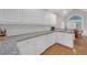 Bright kitchen featuring white cabinetry, granite countertops, and stainless-steel appliances at 8108 Greens Mill Way, Loganville, GA 30052