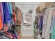 Well-organized walk-in closet with ample hanging space, shelving, and storage options for efficient organization at 8108 Greens Mill Way, Loganville, GA 30052