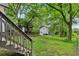 View of backyard and back of home showing stairs leading to back door and shed structures at 2860 Jefferson St, Austell, GA 30106