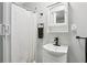 This bathroom features a sleek white vanity and cabinet, with a modern black faucet and neutral shower curtain at 2860 Jefferson St, Austell, GA 30106