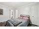 This bedroom offers a comfortable bed and stylish flooring, bathed in soft, natural light from the windows at 2860 Jefferson St, Austell, GA 30106