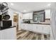 Kitchen featuring white cabinets, stainless steel appliances, dark countertops, and stylish wood-look floors at 2860 Jefferson St, Austell, GA 30106