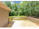 Wood back deck overlooking backyard filled with mature trees at 4810 Habersham Se Way, Conyers, GA 30094