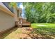 Home's back yard featuring deck, grassy lawn and mature trees at 4810 Habersham Se Way, Conyers, GA 30094
