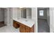 Bathroom showcasing double vanity with wood cabinetry and a view into the bedroom and soaking tub at 4810 Habersham Se Way, Conyers, GA 30094
