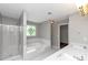 Bright bathroom featuring separate shower and soaking tub with double sinks and decorative window detail at 4810 Habersham Se Way, Conyers, GA 30094