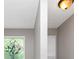 Close up of a decorative stained glass window and modern lighting fixture in bathroom at 4810 Habersham Se Way, Conyers, GA 30094