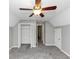 A spacious bedroom with a ceiling fan, closet, carpet, and neutral walls at 4810 Habersham Se Way, Conyers, GA 30094