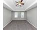 Spacious bedroom featuring neutral walls, plush carpeting, ceiling fan and natural light from two windows at 4810 Habersham Se Way, Conyers, GA 30094