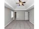 Carpeted main bedroom features tray ceiling, neutral paint, and two doorways adding character to the room at 4810 Habersham Se Way, Conyers, GA 30094