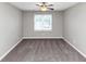 Bedroom features neutral walls, carpeted flooring, natural light from large window and ceiling fan at 4810 Habersham Se Way, Conyers, GA 30094