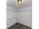 Walk-in closet with white shelving, overhead light, and neutral walls, carpeted floors at 4810 Habersham Se Way, Conyers, GA 30094