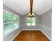 Bright dining room with hardwood floors, complemented by natural light streaming through large windows at 4810 Habersham Se Way, Conyers, GA 30094