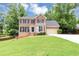 Charming two-story brick home with well-manicured lawn and attached two-car garage at 4810 Habersham Se Way, Conyers, GA 30094