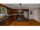 Kitchen boasts wooden cabinets, dark countertops, stainless steel appliances, and center island with granite top at 4810 Habersham Se Way, Conyers, GA 30094