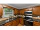 Modern kitchen featuring granite countertops, stainless steel appliances, and light wood cabinets for a warm appeal at 4810 Habersham Se Way, Conyers, GA 30094