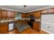 Open kitchen with wood cabinets, granite counters, stainless appliances and center island offering cooking space at 4810 Habersham Se Way, Conyers, GA 30094