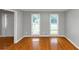 Bright living room with hardwood floors and two windows at 4810 Habersham Se Way, Conyers, GA 30094