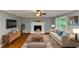 Staged living room featuring hardwood floors, fireplace, seating and natural lighting at 4810 Habersham Se Way, Conyers, GA 30094