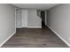 A room with hard flooring, neutral walls, and multiple white doors at 4810 Habersham Se Way, Conyers, GA 30094