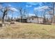 Spacious backyard with a view of the home's white brick exterior and screened in back patio at 5774 Forest Dr, Acworth, GA 30102
