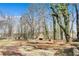 Spacious yard features a fire pit and fireplace area, with beautiful views at 5774 Forest Dr, Acworth, GA 30102