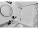 Bright bathroom features granite counters, round mirror, and tiled shower and tub at 5774 Forest Dr, Acworth, GA 30102