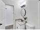 Bathroom featuring granite counters, a round mirror and modern lighting at 5774 Forest Dr, Acworth, GA 30102