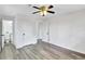 Bright bedroom featuring gray vinyl floors, ceiling fan, and white painted walls at 5774 Forest Dr, Acworth, GA 30102