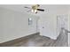 Bedroom featuring gray vinyl floors and white walls, with an open closet and window at 5774 Forest Dr, Acworth, GA 30102