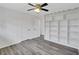 Bedroom with hardwood floors, a ceiling fan and custom shelving at 5774 Forest Dr, Acworth, GA 30102