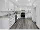 Modern kitchen with white cabinets, granite countertops, and stainless steel appliances at 5774 Forest Dr, Acworth, GA 30102