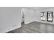 Living room featuring hardwood floors, white walls and access to the bathroom and back patio at 5774 Forest Dr, Acworth, GA 30102