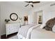 Stylish bedroom featuring a comfortable bed, white dresser, and views to the kitchen and bathroom at 1101 Juniper Ne St # 1012, Atlanta, GA 30309