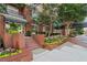 Landscaped brick building entrance with manicured flower beds and wrought iron railings at 1101 Juniper Ne St # 1012, Atlanta, GA 30309