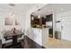 Bright dining room with dark wood floors and a view into the modern kitchen with stainless appliances at 1101 Juniper Ne St # 1012, Atlanta, GA 30309