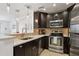 Modern kitchen with stainless steel appliances, dark cabinets, and an open view into the living area at 1101 Juniper Ne St # 1012, Atlanta, GA 30309