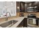 Updated kitchen featuring dark cabinets and stainless steel appliances adjacent to the living room at 1101 Juniper Ne St # 1012, Atlanta, GA 30309
