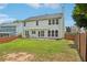 Spacious backyard with a pergola, swing, well-maintained lawn and a wooden fence at 153 Towey Trl, Woodstock, GA 30188